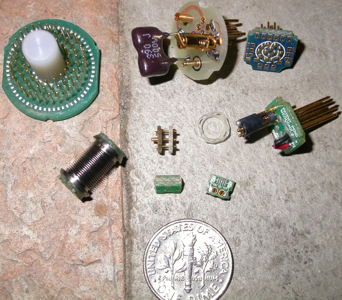 Various items designed by Aaron Fine with dime for scale